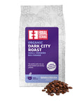 Organic Dark City Roast Whole Bean Coffee bag with a pile of coffee beans