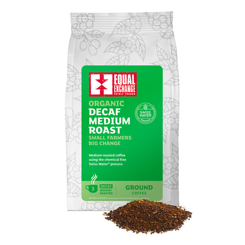 front of Organic Decaf Medium Roast coffee bag with pile of ground coffee