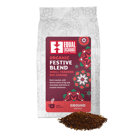 front of Organic Festive Blend ground coffee bag with pile of ground coffee