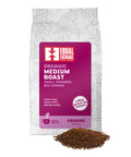 front of Organic Medium Roast coffee bag with pile of ground coffee