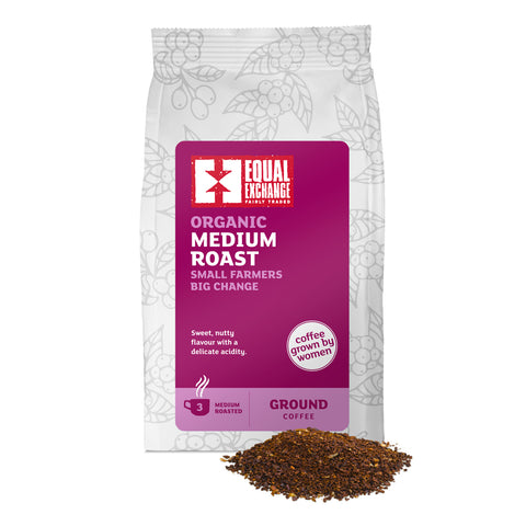 front of Organic Medium Roast coffee bag with pile of ground coffee