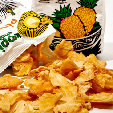 open Tropical Wholefoods bag with dried pineapples spilling out