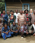 group of Sopacdi cooperative members gathered with Equal Exchange coffee quality manager in front of wooden building